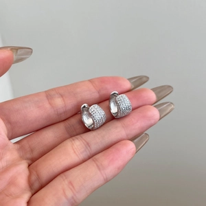 Detailed close-up of S925 sterling silver hoop earrings with full pave cubic zirconia
