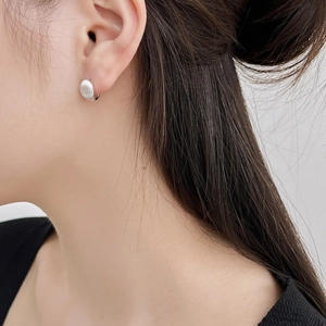 Minimalist S925 sterling silver stud earrings with brushed matte finish on female model