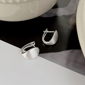 Detail of S925 sterling silver hoop earrings with a matte brushed metal finish
