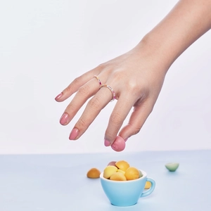 Detail of S925 sterling silver ring with colorful zircon stones on model hand