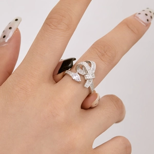 Detailed view of S925 silver bow ring featuring a pear-cut zircon and micro-pave setting