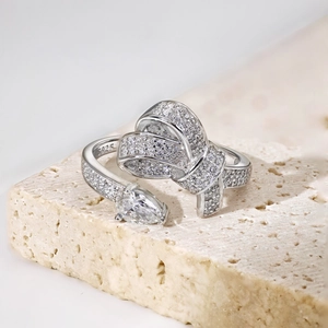 Detailed close-up of S925 silver bow ring with sparkling zircons and pear-cut stone