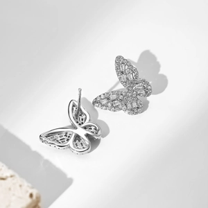Macro shot of silver butterfly stud earrings with sparkling cubic zirconia pavé stones