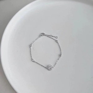 Detail of S925 sterling silver bracelet with halo zircon pendant and lobster clasp