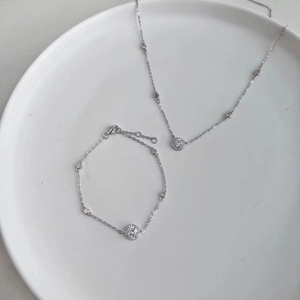 Macro view of S925 sterling silver jewelry set with circular micro-pave diamond elements