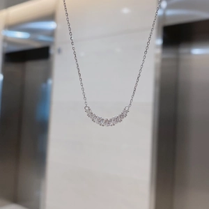 Detailed view of silver S925 sterling silver U-shaped pendant set with sparkling zircons