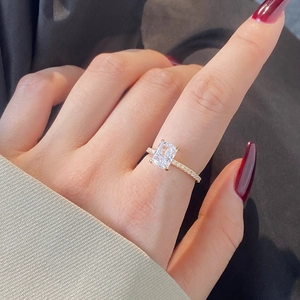 Close-up of S925 silver ring with rectangular ice-cut zircon and gold pavé band