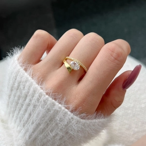 Detailed view of an oval cut crystal ring on a model with a gold double layer band design