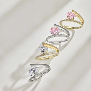Detail of S925 silver bypass rings with oval ice-cut gemstones and pave diamonds