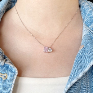 Close-up of S925 silver necklace featuring radiant pink and heart-cut stones on a model