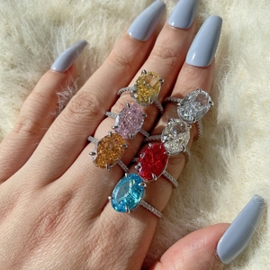 Macro shot of S925 silver rings with colorful oval zircon gemstones on faux fur