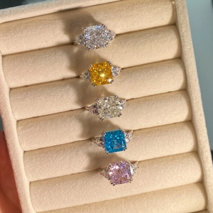 Five radiant cut s925 silver rings with colorful cubic zirconia in a velvet box