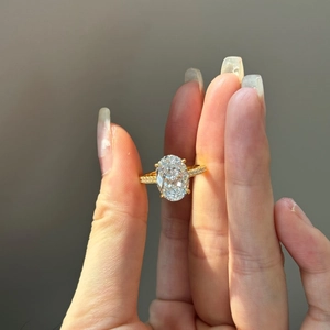 Macro shot of 18K gold ring with large oval cut zircon and micro-pave diamond setting