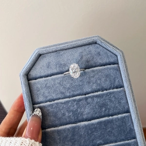 Close-up of luxury S925 silver ring with oval ice-cut zircon in a blue velvet box