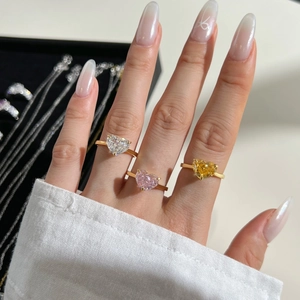 Close-up of three S925 silver rings with heart-cut colorful zircon in gold plating
