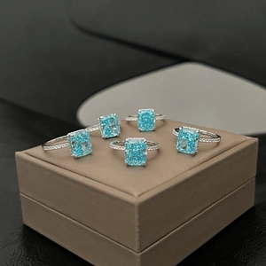 Close-up of five S925 silver rings featuring emerald-cut blue zircon and pavé setting