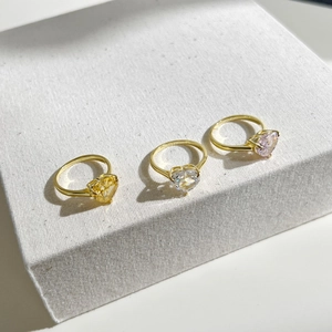 Detailed macro view of S925 silver heart-shaped zircon rings in multiple colors