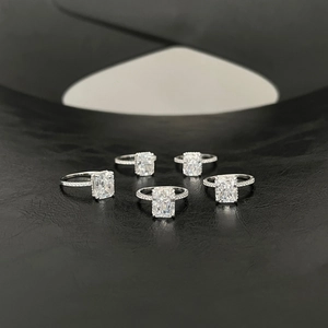 Group shot of rectangular ice-cut zircon rings on a textured black leather background