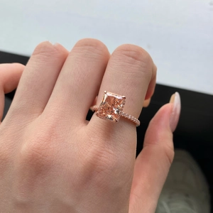 Macro shot of rose gold ring featuring a rectangle champagne gemstone and micro diamonds