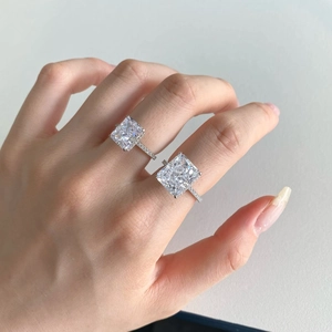 Close-up of dual s925 silver rings with radiant cut square cubic zirconia and pavé stones