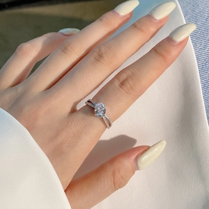Macro shot of S925 silver ring featuring an oval pink zircon with crisscross diamond band
