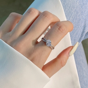 Detailed view of an oval pink zircon ring with a double-track crisscross pavé silver band