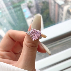 Close-up of S925 sterling silver ring with a pink heart-shaped radiant cut gemstone