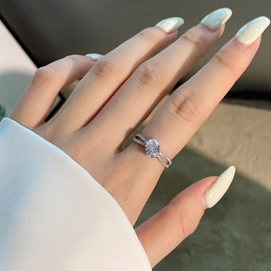 Detail of S925 silver ring featuring an oval pink zircon and crisscross diamond band