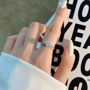 Detail view of oval pink zircon sterling silver ring on hand with double pavé band