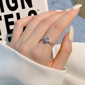 Detail of S925 silver ring featuring an oval pink zircon and split pave band design