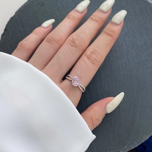 Close-up of S925 silver ring featuring pink oval zircon and pavé twisted band