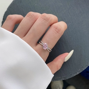 Close-up of S925 silver ring featuring an oval pink zircon and diamond-set entwined band