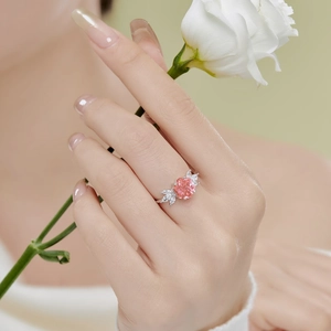 Close-up of pink round-cut gemstone ring with marquise diamonds on S925 silver band