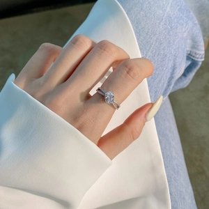 S925 silver ring featuring an oval pink zircon and crisscross micro-pave diamond band