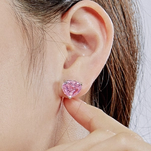 Close-up of S925 sterling silver heart-shaped pink zircon stud earrings on model's ear