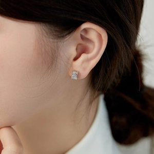 Close-up of radiant cut crystal earring set in a classic four-prong sterling silver mount
