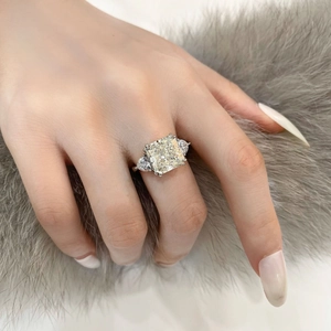 Close-up of radiant cut center stone and pear-shaped side stones on S925 silver ring