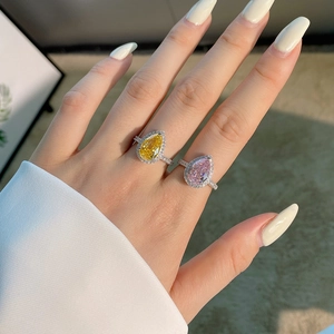 Détail macro de bagues en poire jaune et rose avec sertissage de zircons cubiques brillants