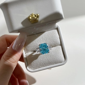Macro shot of 925 sterling silver ring with blue radiant cut zircon and triangle side stones