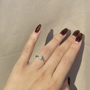 Close-up of a classic S925 silver ring featuring a round sparkling solitaire zircon