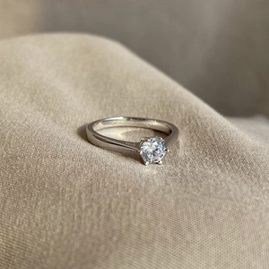 Detailed view of a classic six-prong setting engagement ring with a sparkling zircon stone