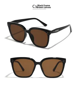 Detail view of oversized retro sunglasses in C3 black frame with brown lenses and metal studs