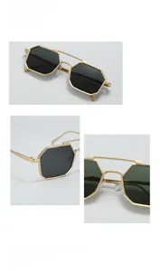 Detailed close-up of octagonal gold metal frame sunglasses with double bridge structure
