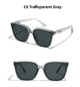 Detail view of transparent grey square sunglasses with stylish metal rivet accents