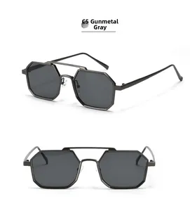 Detailed close-up of gunmetal polygonal sunglasses with double bridge and dark lenses