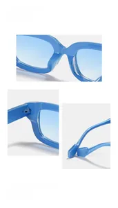 Macro detail of bright blue cat-eye sunglasses showing metal hinges and nose pads
