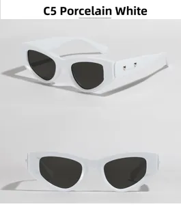 Dettaglio degli occhiali da sole bianchi cat-eye con rivetti in metallo a cuore
