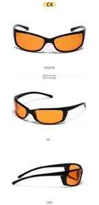 Detail view of Y2K cycling sunglasses with black frames and translucent orange lenses