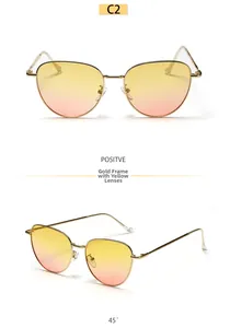 Detail view of cat eye metal sunglasses with gold frame and yellow gradient lenses