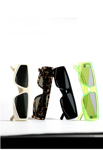 Detail showing four stylish rhinestone-rimmed rectangular sunglasses in various colors